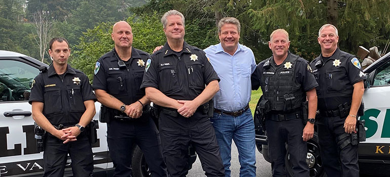 Councilmember Dunn standing with several King County sheriffs.