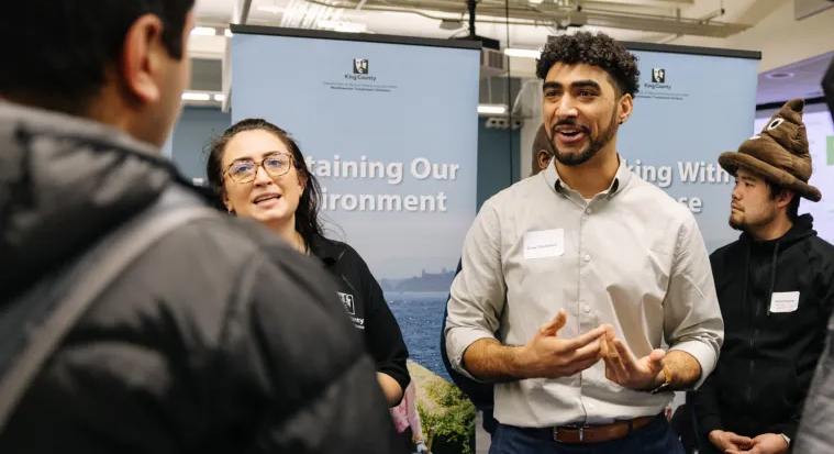 King County staff talking to attendees at the Green Jobs Symposium and Career Fair hosted at South Seattle College