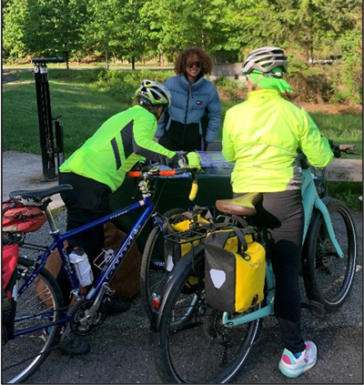 Community engagement staff sharing project information with trail users