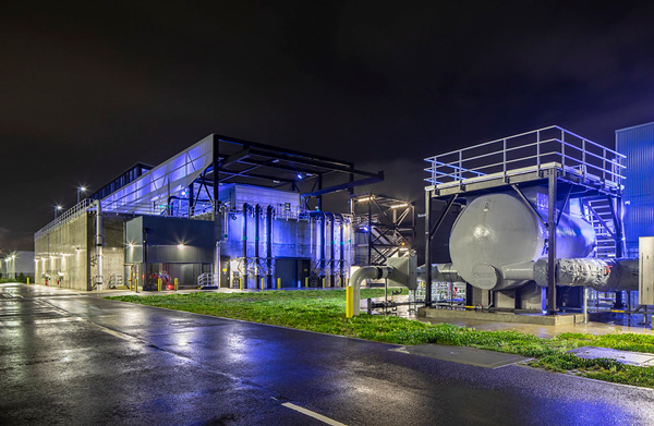 Georgetown wet weather station at night, blue lights illuminate the building.