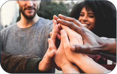 Icon image of people of different races putting their hands together as a show of support