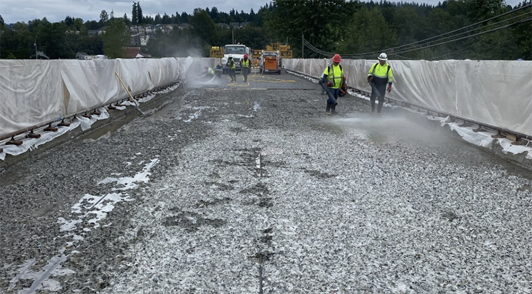 Pressure washing the bridge deck.