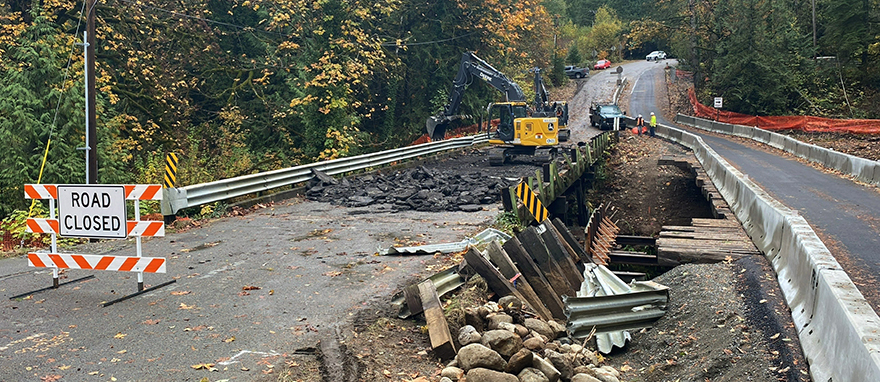 Nov. 7, 2022 – Our contractor crew demolishes the old bridge before they build the new permanent bridge. All traffic will use the temporary bridge (shown here on the right) during construction.